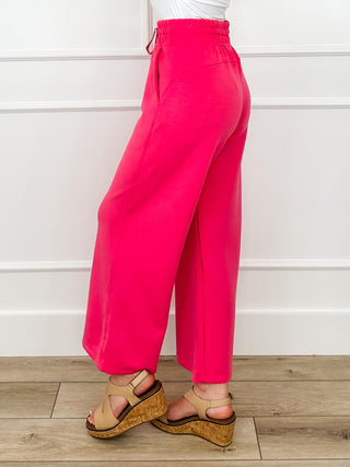 Bright pink high-rise wide-leg bottoms with elastic drawstring waist