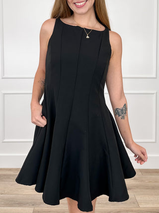 Black sleeveless fit-and-flare dress with scoop neckline and front seam details