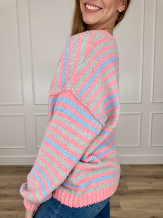 Multi striped knit long-sleeve sweater, side view; ribbed cuffs and hem