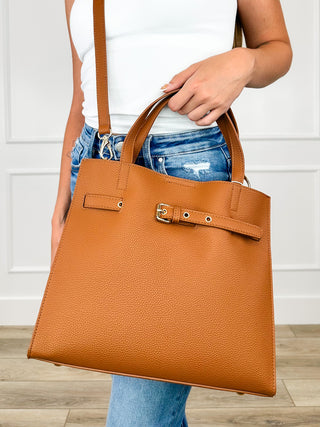 Cognac faux leather tote bag with front buckle strap and top handles