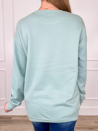 Light green women's crewneck sweatshirt, long sleeves, back view