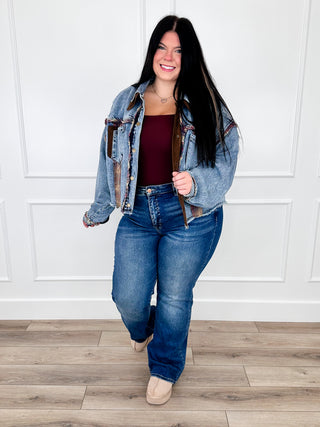 Dark wash straight-leg jeans with distressed rips and frayed knees