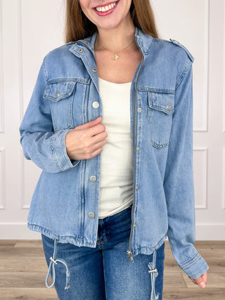Medium-wash denim jacket with button front, flap chest pockets, long sleeves