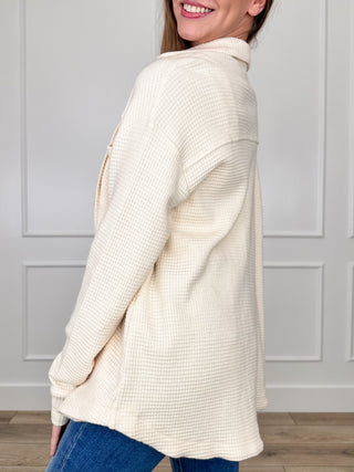 Cream knit button-up shacket, long sleeves, side view with button placket and collar