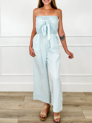 Blue cropped strapless jumpsuit with smocked bodice and bow-tied neckline, wide legs