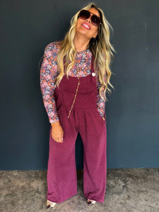 Wine red ribbed overalls with bib front, button straps, and wide-leg pants