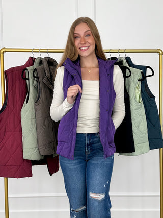 Purple quilted puffer vest with snap-trim collar and zip front