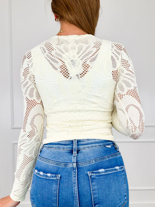 Cream long-sleeve lace top, back view, openwork pattern and crew neckline