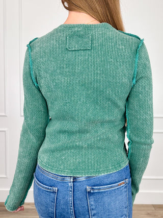 Green long-sleeve knit Henley top, back view with button placket and back patch detail