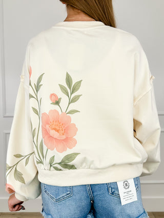 Cream cotton-blend long sleeve pullover top with large floral print on back