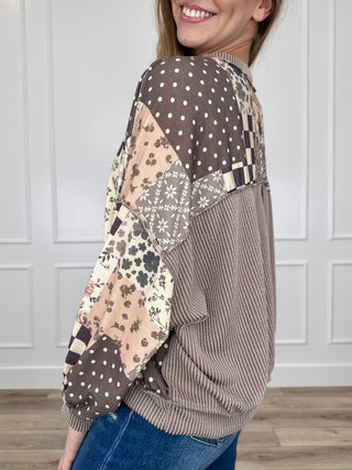 Brown patchwork long-sleeve top with ribbed cuffs, floral dots and check blocks