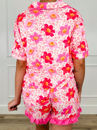 Pink floral PJ set with button front and ruffle trim shorts, seen from back