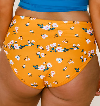 High-rise swim bottoms in orange with allover daisy floral print