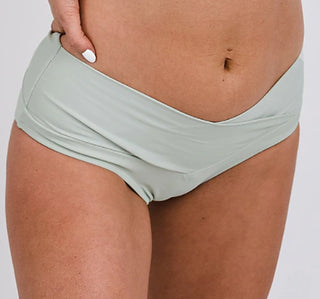 Sage green low-rise swim bottoms with ruched waistband, smooth bikini cut