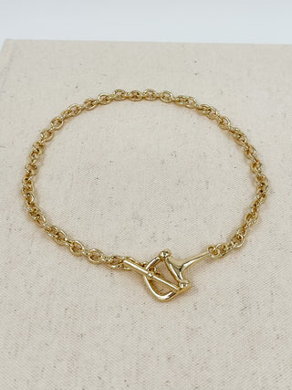 Gold-tone chain necklace with centered square pendant and cross detail