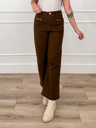 Brown high-rise wide-leg denim jeans with front pockets and button closure