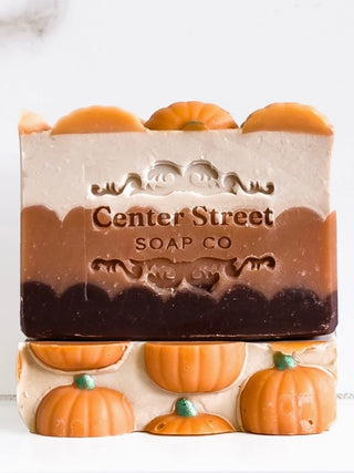 Center Street soap bar: orange pumpkin top, white label, stacked with pumpkin shapes