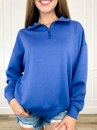Blue quarter-zip pullover sweatshirt with long sleeves and half zipper