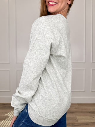 Grey crewneck long-sleeve sweatshirt, side profile