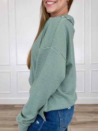 Green striped long-sleeve half-zip sweatshirt, side view with ribbed cuffs