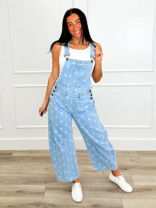 Light blue printed denim overalls with front bib, wide straight legs and adjustable straps