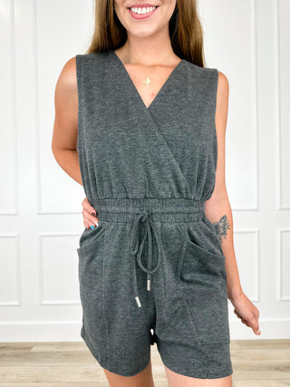 Heathered knit romper in dark grey, sleeveless V-neck with tie waist and shorts.
