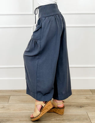 Dark blue high-rise wide-leg cropped pants with elastic waist, drawstring, pockets