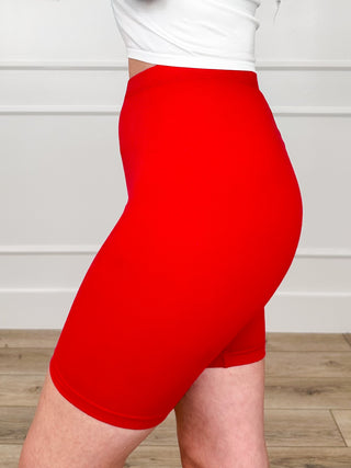 Red high-rise biker shorts, side angle with wide waistband