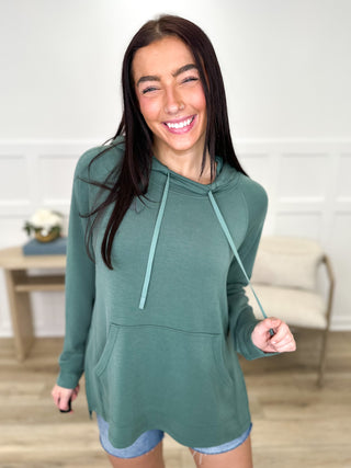Lightweight green long-sleeve hooded top with hood, kangaroo pocket, and drawstring ties