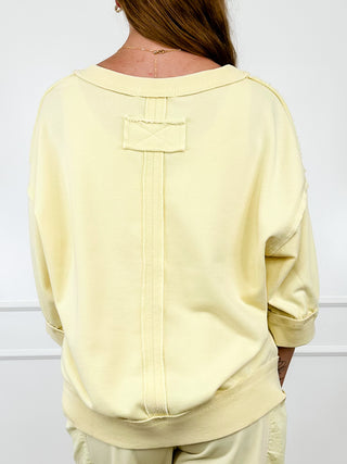 Yellow cotton-blend short-sleeve top, back yoke detail with vertical seam