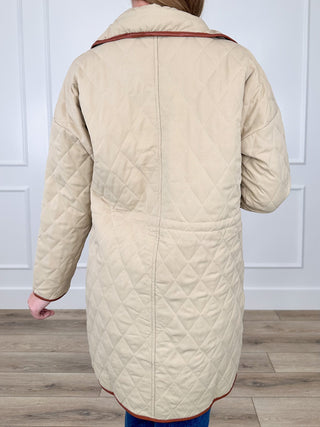 Sand quilted long-sleeve jacket back with diamond stitching and red-trim collar