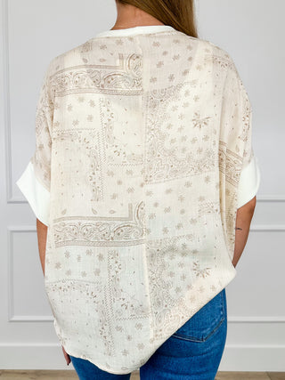 Rayon blend short-sleeve top back view in light oatmeal with ornate pattern