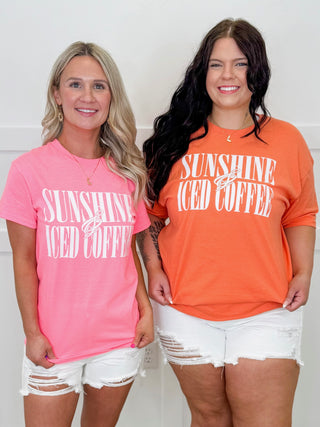 Two women wearing 'Sunshine Iced Coffee' shirts in pink and orange.