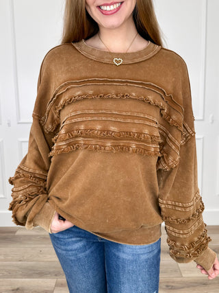 Brown long-sleeve cotton top with ruffled layered chest panels and stitched trim
