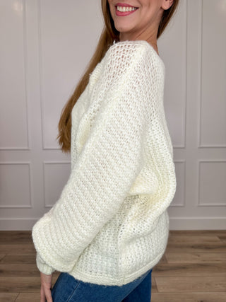 Ivory knit long-sleeve sweater with ribbed cuffs and rounded neckline