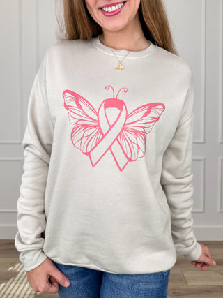 Oat crewneck sweatshirt with pink butterfly-ribbon graphic and long sleeves