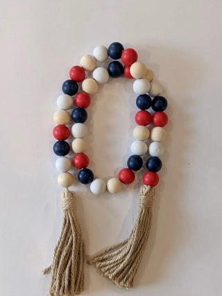 Beaded wood garland with multicolor wooden beads and two rope tassels