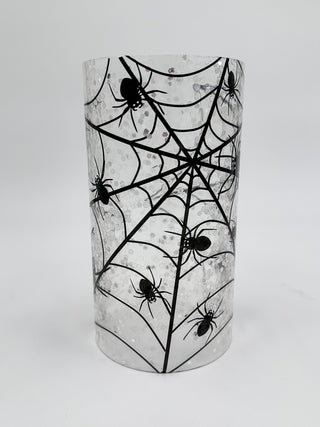 Glass candle slip cover with spiderweb and spider silhouettes in dark accents