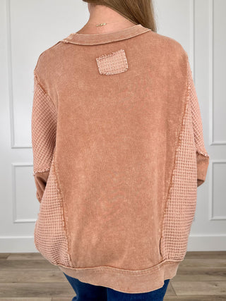 Clay cotton long-sleeve crewneck top, back view with small square detail at collar
