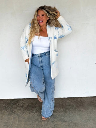 White chenille long sleeve cardigan with blue bow and flower pattern, open front