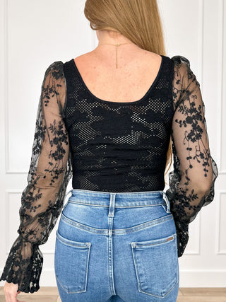 Black knit bodysuit with long sheer lace sleeves and scoop neckline