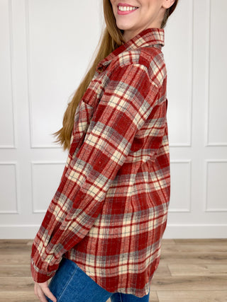 Brick red plaid flannel shacket with long sleeves and button-up front