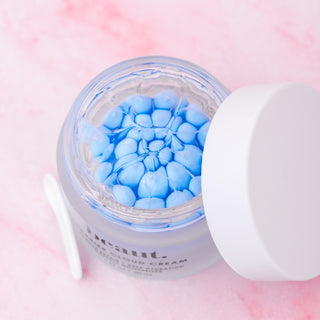 Beaut Barrier Cloud Cream jar open, showing blue gel beads inside