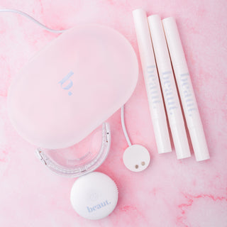 Teeth whitening light kit contents: three white pens and circular discs