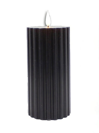 Black ribbed LED candle with a glowing flame on top