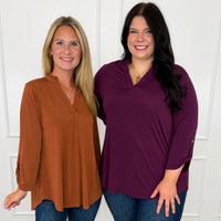 Two women wearing Dear Scarlett 3/4 sleeve V-neck tops in rust and plum from the Avery Mae Boutique, in size inclusive regular and curvy sizes.