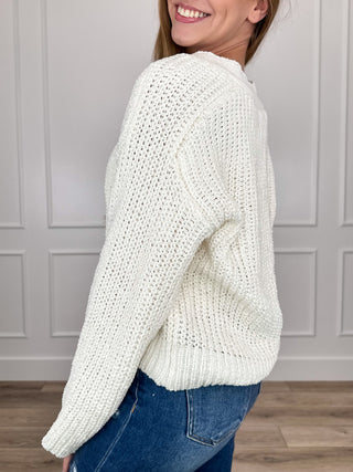 Ivory knit button-up cardigan with long sleeves, ribbed cuffs, and hem