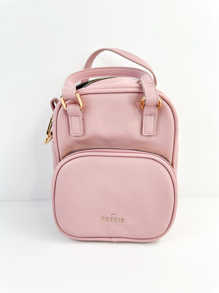 Pink faux leather mini backpack bag with front zipper pocket and top zip closure