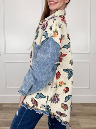 Cream knit long-sleeve jacket with multicolor butterfly print, side view, frayed hem