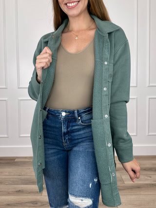 Taupe long-sleeve shacket front view with point collar, button placket, and chest pockets